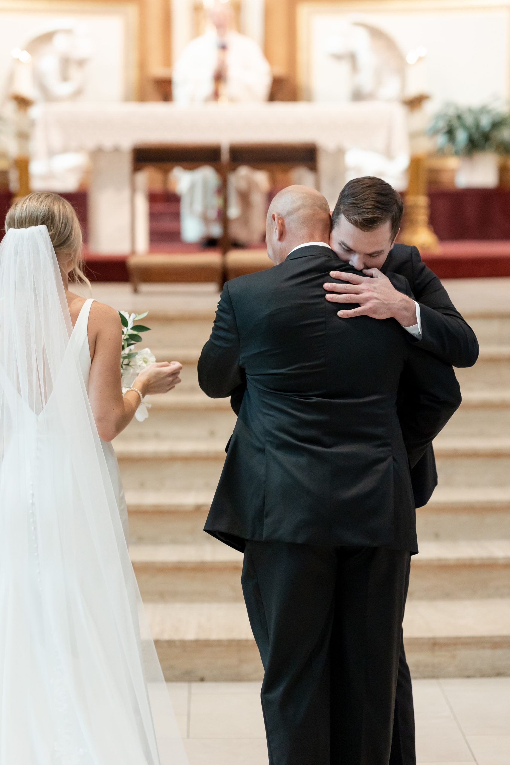 father-bride-groom-hug-wedding-ceremony